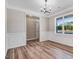 Dining room featuring elegant wainscoting, wood floors, and a stylish chandelier at 9391 Turkey Way, Middlesex, NC 27557