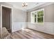 Dining room featuring wainscoting, laminate flooring, and an outdoor view at 9391 Turkey Way, Middlesex, NC 27557
