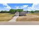New construction single-Gathering home with a well-manicured lawn, long driveway, and an attached garage at 9391 Turkey Way, Middlesex, NC 27557