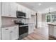 Modern kitchen features stainless steel appliances, granite counters, subway tile and wood floors at 9391 Turkey Way, Middlesex, NC 27557