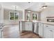 Open kitchen boasts granite countertops, stainless appliances, a breakfast area and wood floors at 9391 Turkey Way, Middlesex, NC 27557