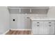 Bright laundry room features cabinets, granite countertops, shelf, and connections for washer and dryer at 9391 Turkey Way, Middlesex, NC 27557