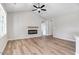 Living room featuring an electric fireplace, ceiling fan, and wood-look laminate flooring at 9391 Turkey Way, Middlesex, NC 27557