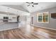 Open-concept living space boasts wood floors, and seamless transition to the kitchen at 9391 Turkey Way, Middlesex, NC 27557