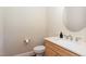 Powder room with a round mirror and quartz countertops at 101 Becklow Ridge Lane Ln, Holly Springs, NC 27540