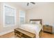 Comfortable bedroom with a wooden bed frame and matching bench and nightstand furniture at 101 Becklow Ridge Lane Ln, Holly Springs, NC 27540