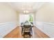 Formal dining room boasts a wood table, panel molding, and access to outdoor views at 101 Becklow Ridge Lane Ln, Holly Springs, NC 27540