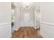 Welcoming foyer featuring hardwood flooring, elegant lighting, and decorative molding at 101 Becklow Ridge Lane Ln, Holly Springs, NC 27540
