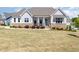 Charming home featuring stone accents, a covered front porch, and well-manicured landscaping at 101 Becklow Ridge Lane Ln, Holly Springs, NC 27540