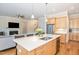 Modern kitchen island with stainless steel appliances, quartz countertops, and wooden cabinets at 101 Becklow Ridge Lane Ln, Holly Springs, NC 27540