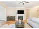 Cozy living room featuring hardwood floors, fireplace, and comfortable seating area at 101 Becklow Ridge Lane Ln, Holly Springs, NC 27540