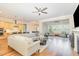 Spacious living room open to the kitchen with hardwood floors and a ceiling fan at 101 Becklow Ridge Lane Ln, Holly Springs, NC 27540