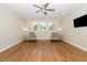 Bright living room showcasing hardwood floors, two cozy chairs, and a ceiling fan at 101 Becklow Ridge Lane Ln, Holly Springs, NC 27540