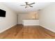 Open living room with hardwood floors, a ceiling fan, and bright recessed lighting at 101 Becklow Ridge Lane Ln, Holly Springs, NC 27540