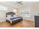 Main bedroom offering hardwood floors, a ceiling fan, and large windows at 101 Becklow Ridge Lane Ln, Holly Springs, NC 27540