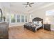 Spacious main bedroom featuring a tray ceiling, hardwood floors, and plentiful natural light at 101 Becklow Ridge Lane Ln, Holly Springs, NC 27540