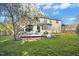 Beautiful backyard view of home featuring large deck, mature trees, and a lush lawn at 101 Silk Leaf, Cary, NC 27518
