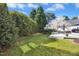 Spacious backyard featuring a well-manicured lawn, mature trees, and stylish deck at 101 Silk Leaf, Cary, NC 27518