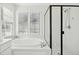 Bathroom featuring a soaking tub with tiled surround, and a frameless glass shower enclosure at 101 Silk Leaf, Cary, NC 27518