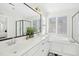 Bright white bathroom with a double vanity, soaking tub, and a glass shower with great natural lighting at 101 Silk Leaf, Cary, NC 27518