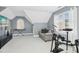 Finished attic bedroom with a drum set, keyboard, and large windows providing natural light at 101 Silk Leaf, Cary, NC 27518