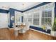 Bright dining room with large windows, elegant lighting, and beautiful blue accent walls at 101 Silk Leaf, Cary, NC 27518
