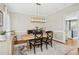 Elegant dining room with a wooden table, unique lighting fixture, and natural light from the windows at 101 Silk Leaf, Cary, NC 27518