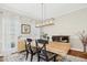 Open dining space featuring a large wood table, chandelier, and neutral wall colors at 101 Silk Leaf, Cary, NC 27518