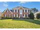 Stunning two-story brick home with black shutters, manicured lawn, and classic architectural details at 101 Silk Leaf, Cary, NC 27518
