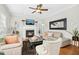 Inviting living room featuring a cozy fireplace, stylish furniture, and modern ceiling fan at 101 Silk Leaf, Cary, NC 27518