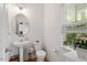 Bathroom features a window with natural light and hardwood flooring at 1029 Frank Page Dr, Cary, NC 27519