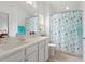 Bathroom with a light floral shower curtain, a white vanity and large mirror at 1029 Frank Page Dr, Cary, NC 27519