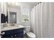 Modern bathroom features a navy blue vanity, chevron pattern shower curtain, and window at 1029 Frank Page Dr, Cary, NC 27519