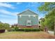 Green two-story townhouse featuring a private deck, well-manicured lawn, and mature landscaping at 1029 Frank Page Dr, Cary, NC 27519