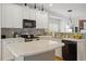 Modern kitchen with white cabinets, subway tile backsplash, and stone countertops at 1029 Frank Page Dr, Cary, NC 27519