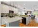 Open kitchen features island and stainless appliances with view of living room at 1029 Frank Page Dr, Cary, NC 27519