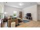 Bright living room with modern decor, laminate floors, neutral paint, and comfortable seating at 1029 Frank Page Dr, Cary, NC 27519