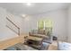 Cozy living room featuring modern decor, laminate floors, and staircase access at 1029 Frank Page Dr, Cary, NC 27519