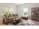 Comfortable living room featuring lots of natural light, modern decor, and laminate floors at 1029 Frank Page Dr, Cary, NC 27519