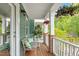 Relaxing front porch with seating, wood floors, and green plants at 1029 Frank Page Dr, Cary, NC 27519