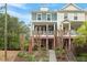 Inviting townhouse with a classic facade, featuring a lovely front porch and well-maintained landscaping at 1029 Frank Page Dr, Cary, NC 27519