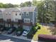 Rear view of townhouse featuring private decks, garage parking, and manicured landscaping at 1029 Frank Page Dr, Cary, NC 27519