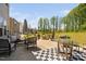 Large backyard patio with multiple seating areas, a fire pit, and views of the expansive lawn at 1036 S Fieldhaven Dr, Fuquay Varina, NC 27526