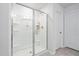 Modern bathroom featuring a glass enclosed shower with built in shelves and tiled floors at 1036 S Fieldhaven Dr, Fuquay Varina, NC 27526