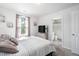 Well lit bedroom with large windows, neutral walls, and TV at 1036 S Fieldhaven Dr, Fuquay Varina, NC 27526
