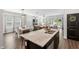 Kitchen island with white granite countertops, stainless appliances, and an open floorplan at 1036 S Fieldhaven Dr, Fuquay Varina, NC 27526