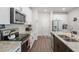 Modern kitchen with stainless steel appliances, granite countertops, and dark wood flooring at 1036 S Fieldhaven Dr, Fuquay Varina, NC 27526