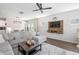 Cozy living room with a large sectional sofa, a modern ceiling fan, and an open-concept layout at 1036 S Fieldhaven Dr, Fuquay Varina, NC 27526