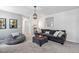 Inviting living room with a comfortable gray sofa, beanbag chair, and soft carpeting at 1036 S Fieldhaven Dr, Fuquay Varina, NC 27526