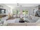 Bright and airy living room featuring a ceiling fan, neutral colors, and access to the backyard at 1036 S Fieldhaven Dr, Fuquay Varina, NC 27526